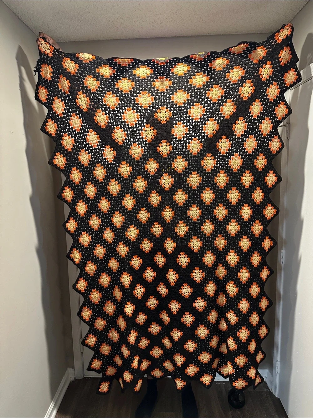 Granny Square black with orange crochet blanket with zig zag hem